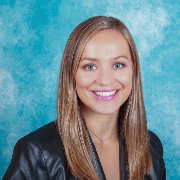Woman's professional headshot on blue background