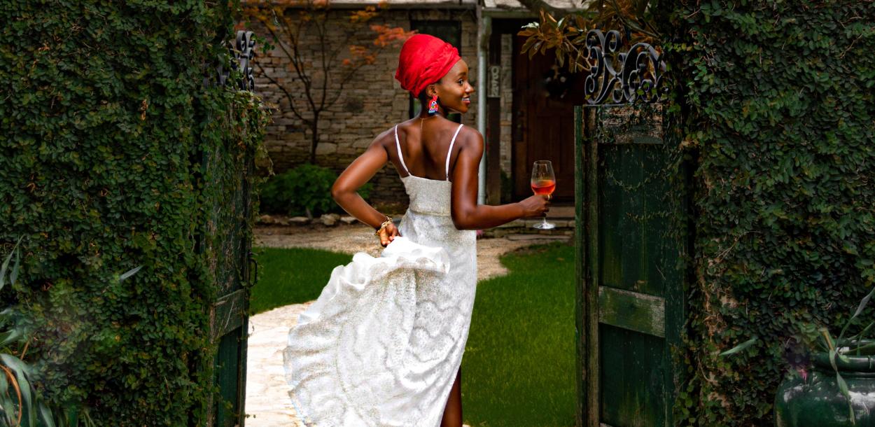 Laolu Onabanjo walks through gate at a winery in Driftwood Texas near Austin\